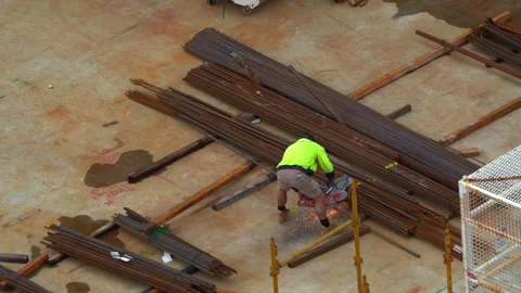 Structural steel erector or ironworker using power tool to cut the steal Stock Footage 242506749