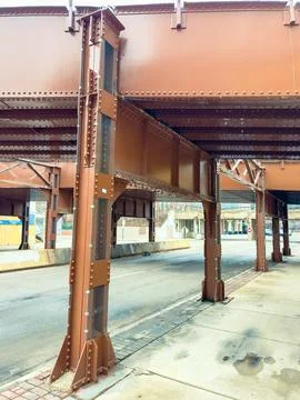 Structural support under an elevated train track in a city, showing steel b.. 스톡 사진