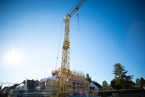 Structural work of a residential building with crane, blue sky Stock Photos