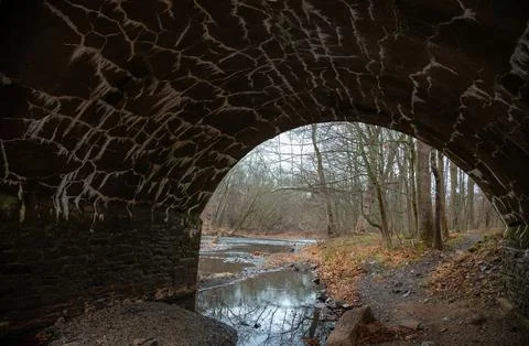 Structure of ancient stonework of eight-arch bridge in  Dark Hollow Park, P.. Stock Photos