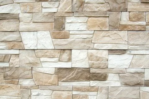 The structure of the beige wall of a beautiful ancient building. Stock Photos