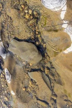 The structure of the bottom is a shallow mountain river, an old man and natur Stock Photos