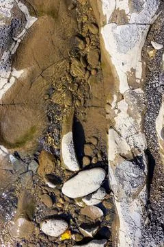 The structure of the bottom is a shallow mountain river, an old man and natur Stock Photos