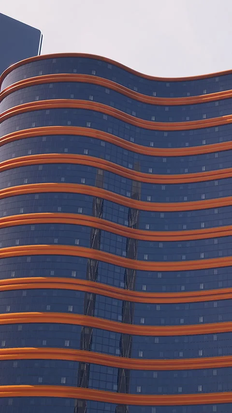 Structure with curved lines and glass facade in urban setting during daytime Stock Footage 340638361