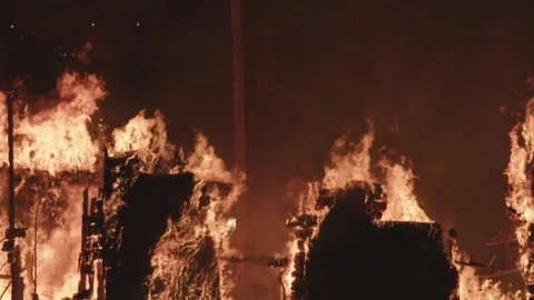 Structure Engulfed in Flames During Massive Fire at Night Stock Footage 312612877