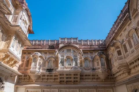 The structure features numerous windows and balconies, showcasing elements of Stock Photos