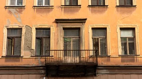 A structure featuring a balcony situated on one of its side walls Stock Photos