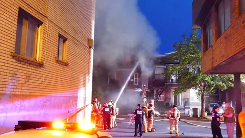 Structure fire during summer with smoke and police officers Stock Footage 115928119