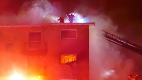 Structure fire with red lights flashing Stock Footage 104298514
