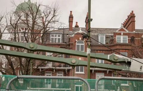 Structure of Hammersmith Bridge with old building background. Stock Photos