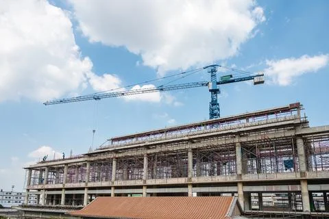 Structure of large building with worker working, crane and scaffold in constr Fotos de archivo