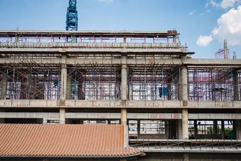 Structure of large building with worker working, crane and scaffold in constr Fotos de archivo