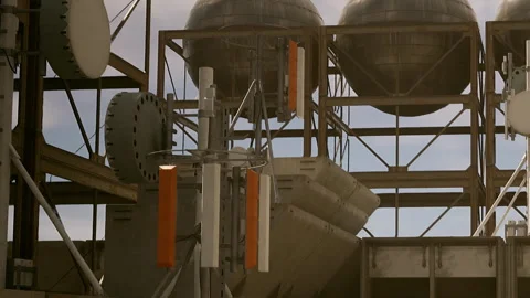 Structure with metallic elements and large spheres during daytime Stock Footage 344060380