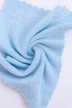 Structure of a microfiber shopping rag. Blue rag on a white background close-up. Stock Photos