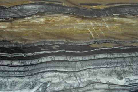 The structure of natural black marble. Gray marble with yellow stripes. Beaut Stock Photos