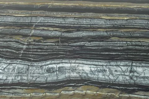 The structure of natural black marble. Gray marble with yellow stripes. Beaut Stock Photos
