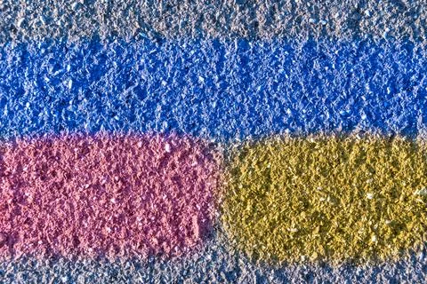 Structure of an old road surface with blue stripe and fragments of yellow and Stock Photos