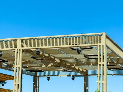 Structure with outdoor canopy in clear blue sky Stock Photos