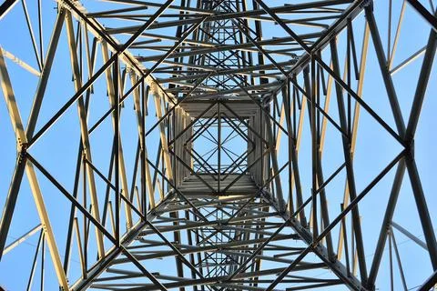 The structure of the power mast seen from the inside. Spring. Stock Photos
