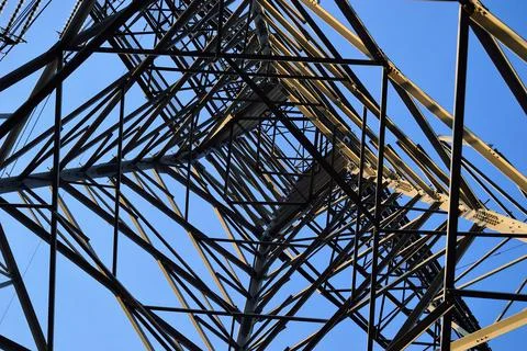 The structure of the power mast seen from the inside. Spring. Stock Photos
