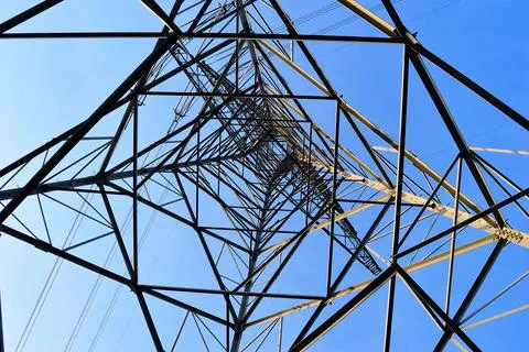 The structure of the power mast seen from the inside. Spring. Stock Photos