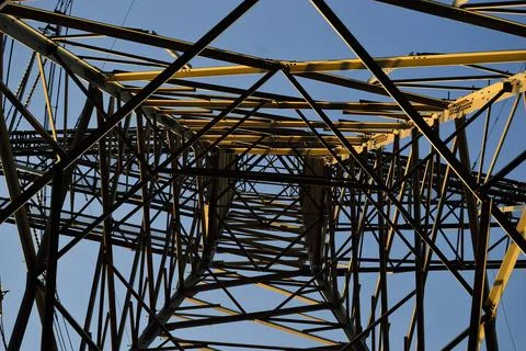 The structure of the power mast seen from the inside. Spring. Stock Photos