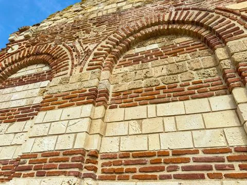 The structure presents old bricks arranged in distinct patterns with curved a Stock Photos