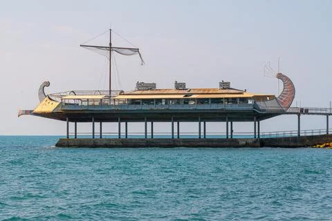 Structure resembling a ship stands over the water Stock Photos