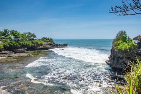 Structure of rock standing on the seashore bubble wave in beautiful sunny day Stock Photos