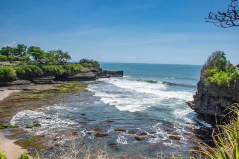 Structure of rock standing on the seashore bubble wave touching green choral  Stock Photos