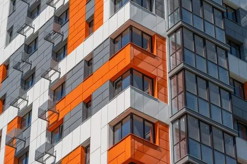 The structure showcases vibrant orange and gray panels, with large glass wind Stock Photos