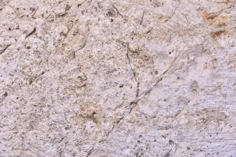 Structure of a stone from an old masonry in a wall of a building of a histori Stock Photos