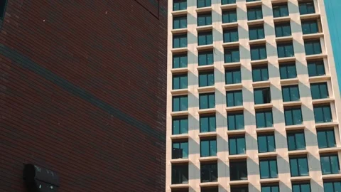 Structure of a tall building with geometric patterns on its facade. The camera Video stock 338446505
