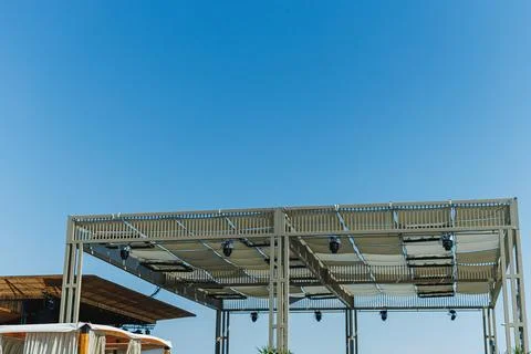 Structure under blue sky at event space in outdoor venue during daytime Stock Photos