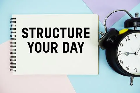 Structure Your Day text written on notepad with alarm clock flat lay on mul.. Stock Photos