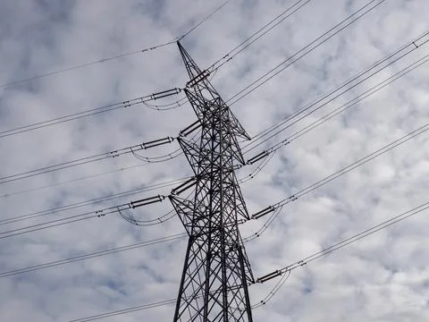 Structured power lines contrast with cloudy textured background creating ar.. Stock Photos