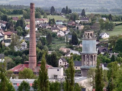 Structures like tall brick chimneys and factories blend into scenic rolling.. Stock Photos