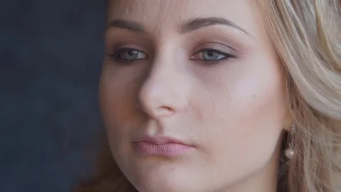 Structuring procedure.Make-up artist puts foundation on the face of the young Stock Footage 69921403