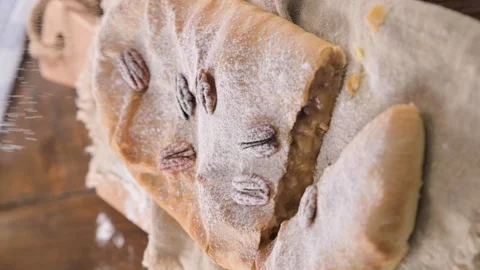Strudel with apple. A typical sweet pastry in northern Italy, in Trento. Pie Stock Footage 213867321