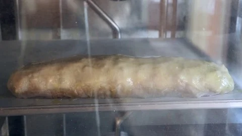 Strudel in the oven. time lipse Stock Footage
