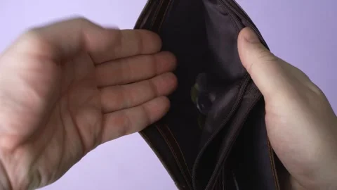 Struggle to save. A man counts the last coins in an empty wallet Stock Footage 303361387