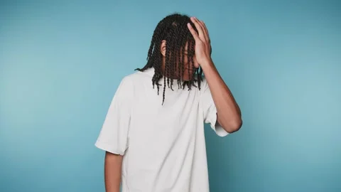 Struggling with emotions in front of a blue background and expressing diffe.. Stock-Footage 328248773