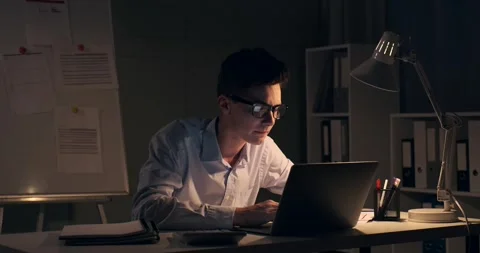 Struggling Office Worker Dealing with Documents in Nighttime Office Stock Footage 250031252