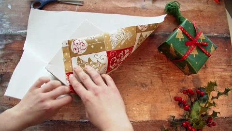 Struggling to properly wrap a Christmas gift neatly Stock Footage 145023686