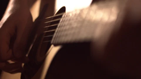 Strumming Acoustic Guitar in Slow Motion Stock Footage