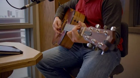 Strumming Acoustic Guitar in studio Stock Footage 75393766