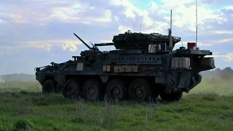 Stryker Armored Fighting Vehicles into position for live fire exercise Stock Footage 273293831