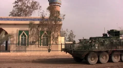 Stryker drives past mosque in Iraq Stock Footage