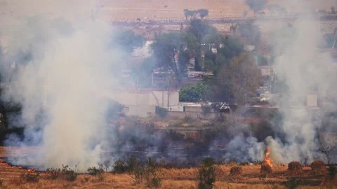Stubble burning field fire near houses Stock Footage 148180701