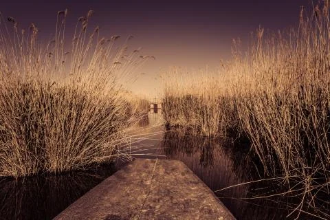 Stubble fields by the river during sunset Stock Photos